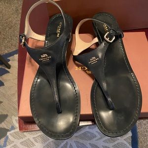 Black leather thong coach sandals.